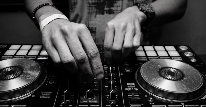 DJ - Grayscale Photography of Person Using Dj Controller