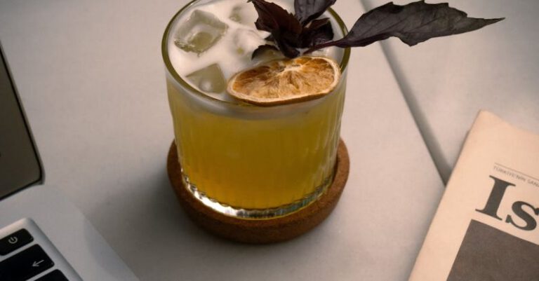 Farm-to-Table - A drink with a leaf on top sitting on top of a laptop