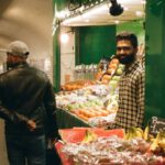 Food Stations - Man Walking Beside Store