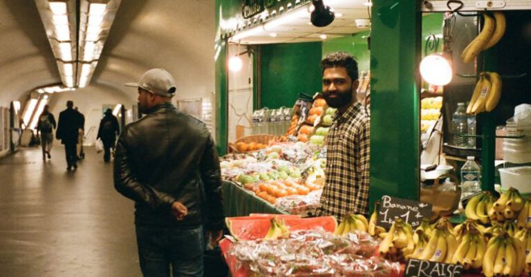 Food Stations - Man Walking Beside Store