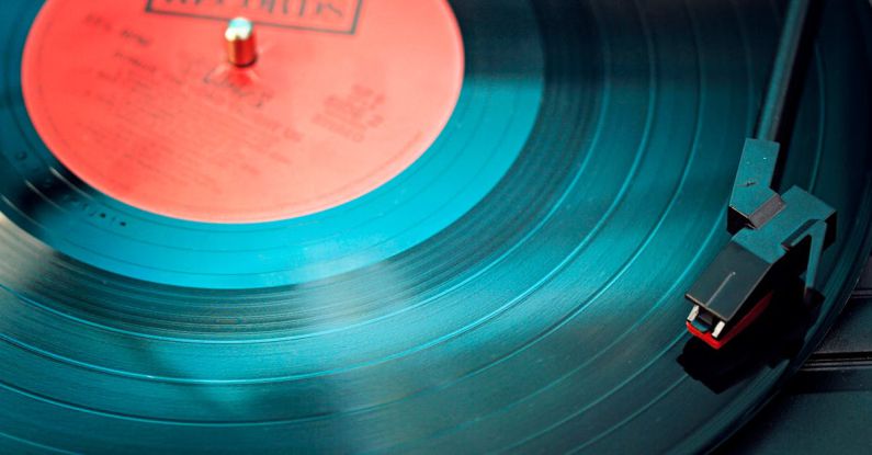 Music - Blue Vinyl Record Playing on Turntable