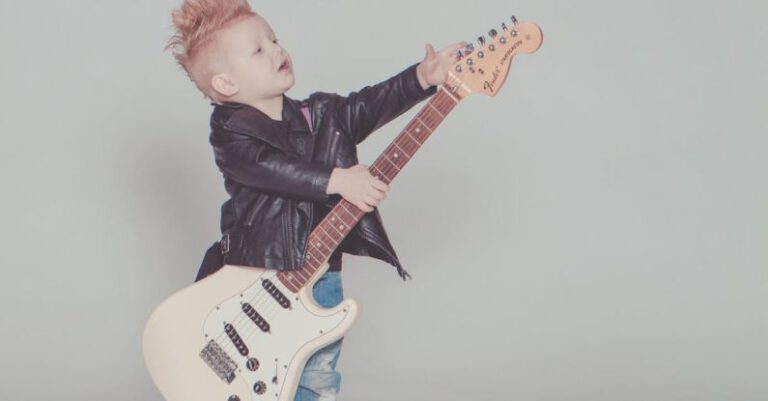 Theme - Boy Wearing Black Jacket Holding Electric Guitar