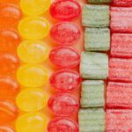 Event Types - From above of various delicious jelly and caramel sweets arranged in rows by type and color in modern candy store