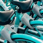 Rental Companies - Teal Bicycles On A Parking Lot