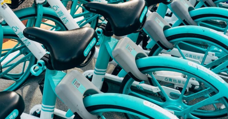 Rental Companies - Teal Bicycles On A Parking Lot